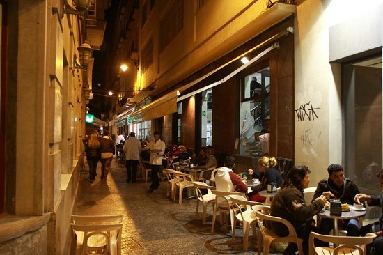Casa Aranda Málaga outdoor seating with locals enjoying churros and coffee in a narrow Old Town street