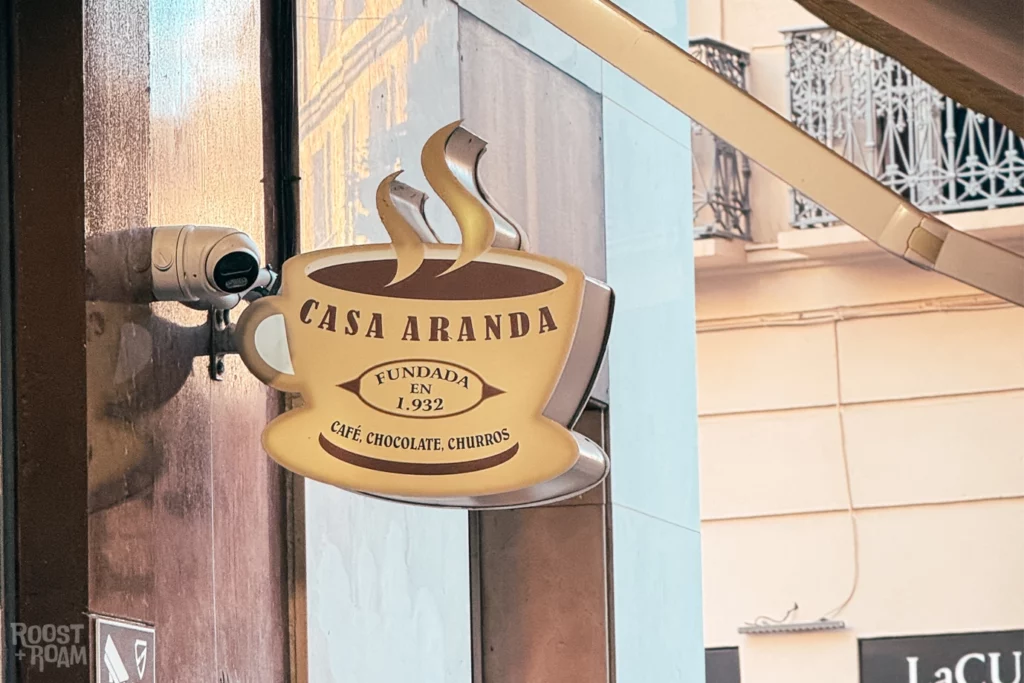 Casa Aranda Málaga sign with coffee cup logo in Old Town street