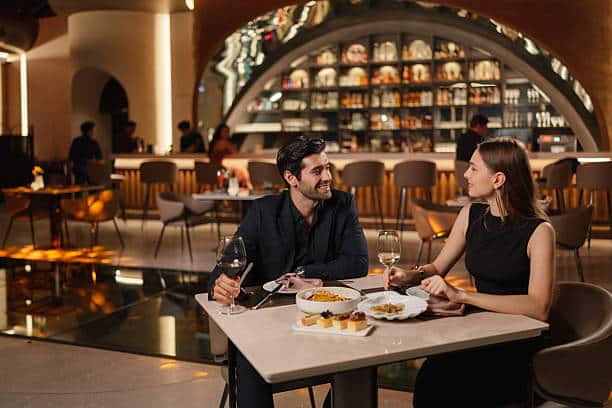 Smiling couple enjoying a romantic dinner in a luxury restaurant.