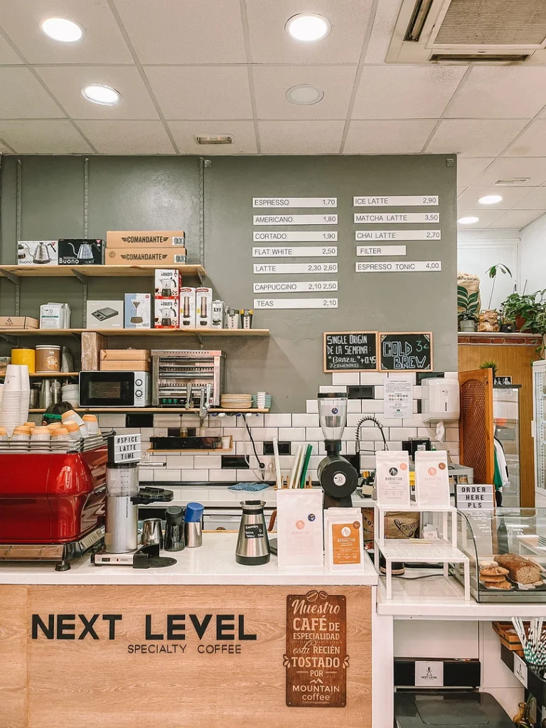 Next Level Specialty Coffee Málaga coffee bar with espresso machine and menu